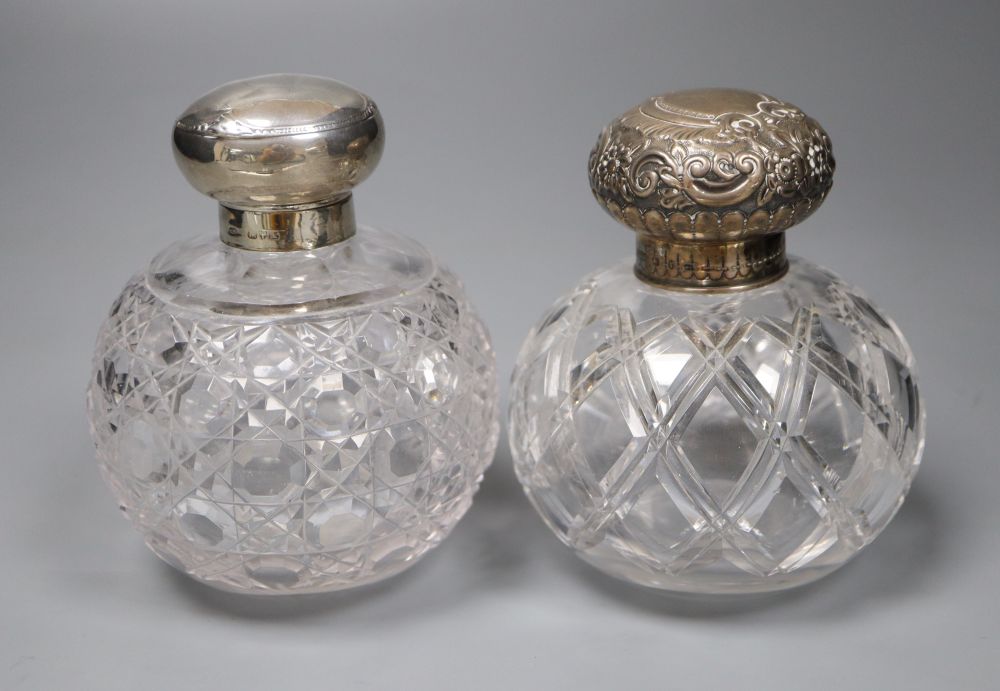 A Victorian silver mounted cut glass scent bottle, 12cm and an Edwardian silver mounted cut glass scent bottle.